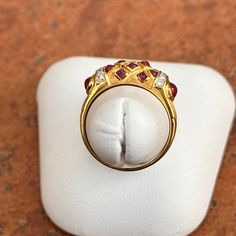 Estate/ vintage 18KT yellow gold Etruscan/ Byzantine design band ring with genuine cabochon red ruby and diamond gemstones. Size: 6.5 Measures: 6.5mm wide 10 Tiny Diamonds .005 carat Weight: 3.90 Grams Stamped 18K Vibrant gold color, almost looks like 22KT Excellent condition Luxury Ruby Cabochon Diamond Ring, Luxury Ruby Ring With Cabochon Cut, Luxury Cabochon Ruby Ring For Anniversary, Classic Gold Cabochon Diamond Ring, Classic Gold Diamond Ring With Cabochon, Yellow Gold Cabochon Ruby Ring, Fine Jewelry Ruby Cabochon Ring, Formal Ruby Ring With Diamond And Oval Cabochon Shape, Exquisite Gold Ruby Gemstone Ring