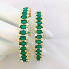 2.6 Green CZ Bangles/Emerald Bangles/CZ Bangles/Traditional Bridal Bangles/Emerald Green Bangles/Indian Bangles/Wedding Jewelry@AryaFashions Features Traditional Z/Green Emerald like Stones Handcrafted To Perfection Light Weight Perfect For Indian Weddings And Celebrations A Beautiful & Memorable Gift for Weddings and Special Occasions Available in 2.6 size The base metal color is Gold tone brass studded with colorful semi-precious CZ stones on it. All our jewelry pictures are taken in natur Green Jeweled Bangle For Party, Party Green Jeweled Bangle, Green Hoop Jewelry For Wedding, Green Hoop Jewelry For Weddings, Green Cubic Zirconia Bangle For Formal Occasions, Green Cubic Zirconia Bangle, Green Bangle With 17 Jewels For Wedding, Wedding Green Emerald Bangle, Green Bangles Indian