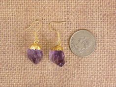 Amethyst crystal point earrings with 24k gold electroplated cap gold plated earwires S12B6-01 Beautiful Natural Amethyst crystals STOCK PHOTOS. Gemstones measure approximately 18mm x 12mm -- each pair will vary slightly because these are natural stones. Earrings measure approx. 40mm in their entirety. Comes in a gift box Gold Amethyst Drop Earrings, Gold Amethyst Earrings With Ear Wire, Gold Amethyst Crystal Earrings With Gemstone, Gold Amethyst Gemstone Crystal Earrings, Gold Amethyst Crystal Earrings, Stones Earrings, Gemstone Earrings Gold, Amethyst Crystals, Crystal Points