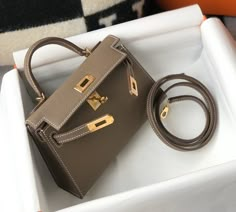 Description HRMS Greige Togo Brown With Gold Toned Hardware Bag For Women, Handbags, Shoulder Bags 7.5in/19cm Rep 1:1 Size: 19 x 11.5 x 5.5 cm / 7.5 x 4.5 x 2.2 inches (Length x Height x Width) Hermès bags are considered the ultimate luxury item worldwide. Each piece is handcrafted with waitlists that can exceed a year or more. The streamlined and demure Kelly style is always in high demand, it is particularly lovely in this vibrant version with gold hardware. Epsom is textured with a wonderful Mini Kelly, Kelly Bag, Fancy Bags, Hermes Handbags, Luxury Products, Hermes Bags, Cute Bags, Leather Messenger, Hermes Bag