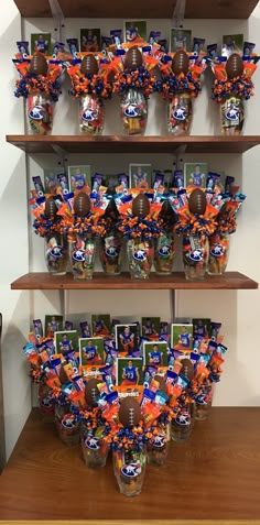 a football themed centerpiece is displayed on shelves