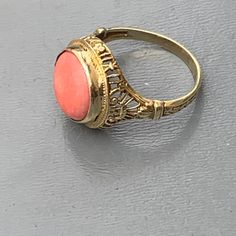 We take pride in finding unique , quality ~ Antique /Vintage jewelry pieces which are carefully hand picked by us so that you can add them to your treasure/ collection or gift to someone you love ~ We try to add plenty of items every week and have been selling online for more then 10 years . Vintage Art Deco ~ 14kt solid gold ~ filigree ring with ta large geuine coral can which is set on an open-back frame . Marked 14kt (also acid tested ) Dates 1920's -1930's Measurements : Ring can fit 6 1/2 - Yellow Gold Filigree Jewelry Ring, Fine Jewelry In 14k Gold With Intricate Design, Antique Carved Yellow Gold Jewelry, Antique Carved Rings For Anniversary, Antique Carved Jewelry For Anniversary, Vintage Carved Rings For Gifts, Fine Jewelry With Intricate Design In 14k Gold, Antique Carved Wedding Rings, Classic Intricate 14k Gold Jewelry