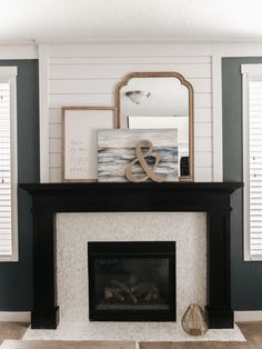 a living room with a fireplace and pictures on the mantle