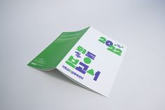 an open brochure with korean writing on the front and back cover is shown