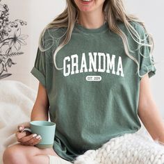 Comfort Colors® Grandma Est. 2024 Shirt, Grandma T-Shirt, Nana Shirt, Gift For Grandma, Gift For Mom, Retro  Grandma Shirt, Gift For Nana A Comfort Colors shirt is a type of casual t-shirt that is known for its softness, relaxed fit, and muted color palette. Typically made from 100% cotton, these shirts have a vintage feel and are often favored for their comfortable, worn-in look. This classic unisex jersey short sleeve and long sleeve tees fits like a well-loved favorite. Soft cotton and quality print make users fall in love with it over and over again. These t-shirts have-ribbed knit collars to bolster shaping. The shoulders have taping for better fit over time. Dual side seams hold the garment's shape for longer.  *6.1 oz./yd² (US), 10 oz/L yd (CA), 100% ring spun cotton, 30 singles *Ga Nana Shirts, Grandma Shirt, Grandma Shirts, Nana Gifts, Gift For Grandma, Comfort Colors Shirt, Grandma Gift, Branded Shirts, Grandma Gifts