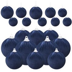 twelve blue velvet baubles with white tassels on each ornament