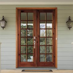 two double doors on the front of a house