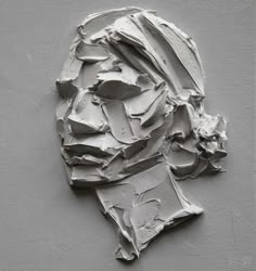 an image of a man's face made out of white paint on a gray background