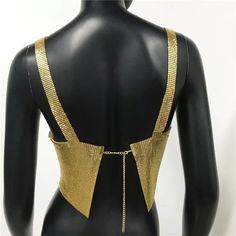 Metal halter top. SIZE Bust: 30”-38 Length: 6,69” Chic Backless Club Tank Top, Party Top With Straps And Stretch Fit, Party Tops With Straps And Stretch Fit, Gold Fitted Cami Top, Summer Club Tank Halter Top, Summer Club Halter Tank Top, Chic Halter Tank Top For Night Out, Party Halter Neck Tank Top With Built-in Bra, Fitted Triangle Top Tank For Night Out