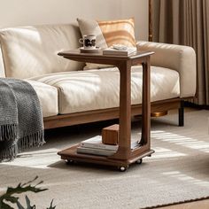 a living room with a couch, coffee table and rugs on the carpeted floor