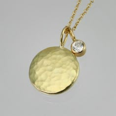 "Beautifully crafted Diamond and 14ky gold pendants on a 16\" 14ky gold chain. Hammered disc is about 1/2 of an inch in diameter. Diamond is a 3mm SI1. Very contemporary, classy, and timeless. Birthstone for April. Comes with a lifetime warranty, polishing cloth, and a gift box." Elegant Luxury Hammered Chain Necklace, 14k Gold Round Coin Necklace Fine Jewelry, 14k Gold Round Pendant Diamond Necklace Polished, 14k Gold Polished Round Pendant Diamond Necklace, 14k Gold Diamond Necklace With Round Pendant, 14k Gold Round Coin Necklace, 14k Gold Round Pendant Diamond Necklace With Polished Finish, Diamond Necklace With Coin Pendant As Gift, Round Diamond Necklace With Coin Pendant As Gift