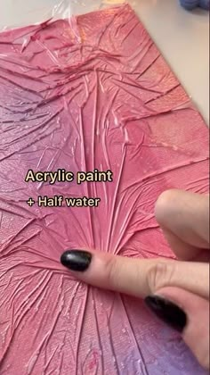 someone using acrylic paint to create a pink flower