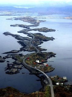 an aerial view of the ocean and road