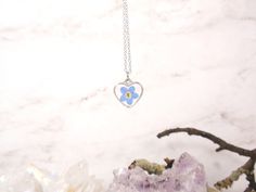 "A simple yet gorgeous everyday piece small wire heart sliding freely along on a delicate silver chain. Great for layering with other delicate necklaces or minimalist wear. Heart silver-tone bezel frame nickel and lead-free - measures about 9/16\"x 1/2\" (14x13 mm), comes with 16\" Hypoallergenic surgical steel chain or Sterling silver chain Each piece is handmade from real pressed flowers. Your design may vary slightly from the picture as each piece is one of a kind! Please keep from extreme mo Small Hypoallergenic Necklace For Gift, Heart Pendant Jewelry With Flower Charm Gift, Mother's Day Jewelry With Heart Charm And Flower Shape, Heart Necklace With Flower Charm As Gift For Her, Mother's Day Flower Jewelry With Heart Charm, Mother's Day Flower Shaped Jewelry With Heart Charm, Dainty Hypoallergenic Flower Necklace, Dainty Heart Necklace With Flower Pendant For Valentine's Day, Dainty Heart Pendant Jewelry With Birth Flower