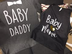 two shirts that say baby, daddy and mama on them sitting next to each other