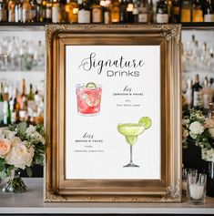 a sign that says signature drinks on the side of a bar with flowers in front of it