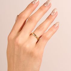 Celebrate the eternal bond of love with our Minimalist Flat Wedding Band. This ring embodies timeless simplicity and elegance. The slender, flat band design in lustrous gold offers a classic and refined look that pairs seamlessly with any engagement ring. Its understated beauty allows it to symbolize the everlasting commitment shared between two souls. - Made in 14k solid gold - Band Width: 2 mm / 0.08 inches - Thickness: 1.2 mm / 0.05 inches - This product comes with an iconic Norm Jewels gift Wedding Ring With Smooth Bezel In 14k Gold, Wedding Rings With Smooth Bezel And Thick Band, Elegant Stackable Wedding Rings With Thick Band, Elegant Wedding Jewelry With Smooth Bezel, Matte Gold Minimalist Jewelry For Anniversary, Wedding Thick Band Stackable Rings With Polished Finish, Thick Band Stackable Rings With Polished Finish For Wedding, Thick Band Polished Stackable Rings For Wedding, Elegant 14k Gold Couple Rings With Thick Band