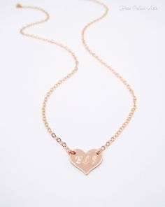 "Small Personalized Heart Necklace - 100% 14k Gold Fill, Rose Gold Fill or Sterling Silver Heart can be personalized with up to three letters or left blank. This is such a dainty and sweet necklace! * We can fit up to 3 letters on this necklace. - Heart is 14k gold fill, 925 sterling or rose gold fill and measures 12mm - Chain is a sturdy yet dainty 14k gold fill, 925 sterling or rose gold fill - Necklace shown at 18\" Inches (The model has a size small neck) - Necklace closes with a spring clas Rose Gold Engraved Heart Necklace For Anniversary, Rose Gold Name Necklace For Valentine's Day Anniversary, Personalized Double Heart Rose Gold Jewelry, Rose Gold Heart Pendant Jewelry With Name, Rose Gold Heart Pendant With Name, Rose Gold Name Engraved Heart Pendant Jewelry, Customizable Rose Gold Necklaces For Valentine's Day, Personalized Double Heart Rose Gold Necklace, Customizable Rose Gold Heart Necklace Gift