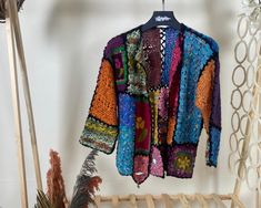 Step into a world of vibrant color and intricate design with our Multicolor Granny Square Crochet Cardigan. This floral, boho hippie-style sweater is the epitome of authentic handmade knitwear, perfect for the eco-conscious fashion lover. Our short Bohemian cardigan is a vintage-inspired hırka, lovingly crafted by skilled artisans. Each crochet jacket is a testament to the art of crochet, made with sustainable fashion knit practices in mind. Yarn 30% Wool, 70% Premium Acrylic Colorful Cardigan L Bohemian Multicolor Outerwear For Spring, Bohemian Fall Festival Sweater, Bohemian Multicolor Long Sleeve Cardigan, Handmade Bohemian Spring Cardigan, Bohemian Long Sleeve Multicolor Cardigan, Multicolor Long Sleeve Bohemian Cardigan, Bohemian Long Sleeve Patchwork Sweater, Bohemian Multicolor Outerwear For Fall, Bohemian Long Sleeve Cardigan For Festivals