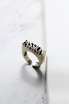 "THE Word on Ring \"PASSION\" original made and designed by Defy The jewelry is designed to have unique style and beautiful details. - The dimensions are ; approx. 0.6 x 2.3 x 0.6 cm. - The Ring size is adjustable between 6-9.5 US.**Please choose options below.** - Material : brass / silver **Free Shipping to World Wide** - Please allow us to prepare the item and parcel between 3-5 working days (*Between 5-7 working days For Sterling Silver 925*) - All items will be sent by Thai Registered Airma Word Ring, Dark Style, Jewelry Words, Letter Ring, Skull Jewelry, Diy Rings, Skull Ring, Style Accessories, Black Crystals