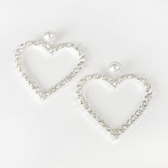 Description Looking for the perfect gift for your darling? The Darling Heart Earrings will put a smile on your loved ones and give them that extra boost in any outfit. These Darling Heart Earrings have pearls in front of the studs with rhinestones designed in heart shaped design. This sparkling elegant statement jewelry will win anyone's heart. Size • Post backing earrings. • Length: 3.3 in (8.38 cm) • Width: 2.5 in (6.35 cm) Quality Designed using top quality eco-friendly silver coated metal al