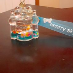 a glass jar filled with water sitting on top of a table next to a sign that says scary sky