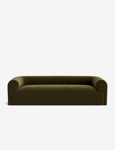 a green couch sitting on top of a white wall