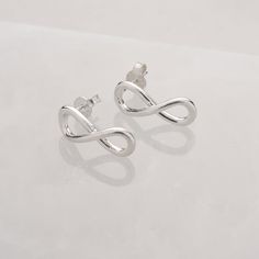 Symbolising a love that knows no bounds, the intricate infinity design represents an unbreakable bond between you and your loved ones. Handcrafted to perfection by our skilled artisan silversmiths, each pair is meticulously fashioned from the finest 925 silver, offering superior quality and durability. The secure scroll fastening ensures comfort and peace of mind, keeping these elegant earrings securely in place all day long We want your jewellery to stay in great condition so you can enjoy it f Jewelry Magazine, Jewellery Pouch, Infinity Design, September Birthstone Jewelry, Zodiac Jewelry, Care Kit, Ear Stud, Jewelry Ring Box, Pearl Jewellery Earrings