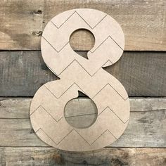 the number 8 is made out of wood and has an arrow pattern on it's side