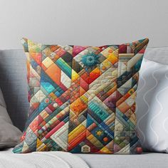 a colorful patchwork pillow sitting on top of a couch