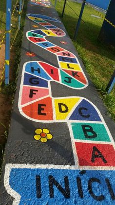 a sidewalk painted with letters and numbers on it