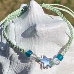 Cute nylon cord friendship bracelet with a metal star charm and accent beads. The size is adjustable and fits to almost any wrist. Can be worn in water. Interested in seeing more? Please check out my store: https://www.etsy.com/shop/OxfordCommaStore Custom requests always welcome! Adjustable Star Bracelets For The Beach, Adjustable Starfish Casual Bracelets, Adjustable Casual Bracelets With Starfish Charm, Casual Adjustable Bracelets With Starfish Charm, Casual Adjustable Bracelet With Starfish Charm, Casual Adjustable Starfish Bracelets, Casual Adjustable Starfish Bracelet, Casual Adjustable Starfish Beaded Bracelets, Casual Adjustable Beaded Bracelet With Star Charm