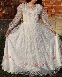 Ethereal vintage floral lace wedding dress Size: S/M Half-girth in cm Bust: 42cm Waist: 33cm Length: 133cm Fitted Lace Dress For Debutante Ball, Floor-length Lace Wedding Dress For Debutante Ball, Spring Wedding Embroidered Lace Dress, Spring Wedding Lace Dress With Lace Collar, Debutante Ball Wedding Dress With Lace Trim, Lace Ball Gown With Lace Sleeves, Spring Wedding Lace Dress With Delicate Lace, Lace Wedding Dress With Lace Sleeves For Ceremony, Floor-length Lace Wedding Dress With Lace Bodice