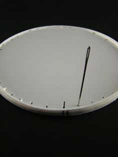 a white clock sitting on top of a black table