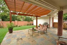 a covered patio area with chairs and tables