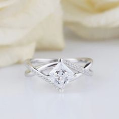 a white gold ring with a princess cut diamond