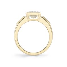 a yellow gold ring with a square shaped diamond on the top and side stones in the middle