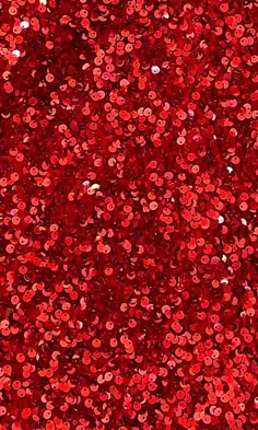 red sequins are scattered on the ground for use as a background or backdrop