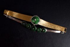 "Fine watch bracelet set with a jade donut and accented with diamonds in 18k. The donut is a deep green Omphacite jade, in parts dark and light like a globe lit. This jewel borrows the perfect finish of a Vacheron watch, its Omega straps in original burnished solid gold. More than a conversion piece, this bracelet could not have been refined to a sleeker layout. At 2cm, the donut is considered big yet its size is offset by the straps, and vice versa. The straps though wide feel made for its cent Elegant Formal Jade Jewelry, Fine Jade Jewelry For Formal Occasions, Luxury Jade Jewelry For Anniversary, Formal Round Jade Jewelry, Timeless Green Jewelry For Evening, Timeless Green Evening Jewelry, Polished Green Jewelry For Evening, Green Polished Jewelry For Evening, Green Polished Evening Jewelry