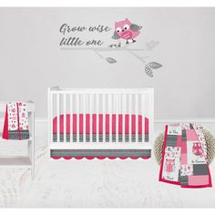 a baby crib bedding set with pink and gray owls on the tree branch