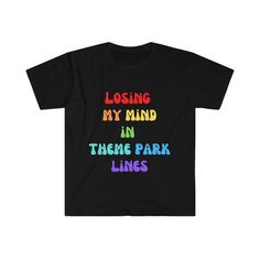 "Inspired by our recent trips to theme parks, here is our t-shirt for the parks! We were \"Losing our Minds in Theme Park Lines\", and maybe you will too! Get one for the whole family, and your matching shirts be so much easier to spot in the crowds! It's a little bit funny, but so much truth, we just had to put it on a shirt!  The unisex soft-style t-shirt puts a new spin on casual comfort. Made from very soft materials, this tee is 100% cotton for solid colors. Heather colors and sports grey include polyester. The shoulders have twill tape for improved durability. There are no side seams. The collar is made with ribbed knitting to prevent curling damage. .: 100% ring-spun cotton (fiber content may vary for different colors) .: Light fabric (4.5 oz/yd (153 g/m)) .: Eurofit .: Tear-away la Cotton T-shirt With Graphic Print For Theme Park, Theme Park Graphic Print Crew Neck T-shirt, Graphic Print Crew Neck T-shirt For Theme Park, Casual Graphic Print Tops For Theme Park, Cotton Graphic Print Tops For Theme Park, Standing In Line, Lose My Mind, Theme Parks, Matching Shirts