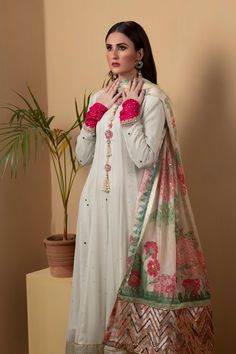 A long chiffon kalidar suit featuring similarly flared pants in shimmering golden silk. The suit features full mukesh work. Paired with a printed dupatta with with silver sequins.3-Piece SuitReady to wear Silk Anarkali Churidar With Mirror Work, Maxi Length Chanderi Salwar Kameez With Mirror Work, Silk Palazzo Set For Wedding, Maxi Length, Silk Maxi Palazzo Set For Wedding, Silk Maxi Length Palazzo Set For Wedding, Maxi Length Salwar Kameez With Mirror Work In Chanderi, Party Sharara In Organza With Naqshi Detailing, Organza Sharara With Naqshi For Party, Party Sharara With Naqshi In Organza