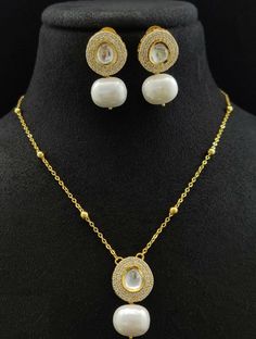 "Golden Pearl Chain / Golden Pearl Necklace / Polki Kundan Pendant Necklace/ White Pearls Chain necklace/ Kundan Pendant Necklace/ JhumkaStop - Trendy Golden Chain Statement Necklace made in Brass with 22 karat gold plating - Necklace comes with chain extension for proper fitting around the neck - Contemporary Minimalist Style Statement Necklace. - 100% guarantee on the finish - Lightweight Indian Jewelry - Necklace Length: Approx. 16 Inches - Earrings: 1\" - Earrings come with Push back closure Elegant Kundan Necklace Gift, Elegant Round Kundan Necklace, Wedding Dangle Chain Necklaces, Elegant Jewelry Sets With Chain For Gift, Gold Kundan Necklace Pendant As Gift, Gold Kundan Pendant Necklace, Pearl Pendant Chain For Celebration, Silver Plated Round Chain Necklace, Silver Kundan Necklace With Pearl Pendant