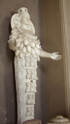 a white statue sitting on top of a table