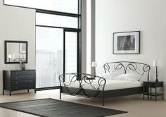 a bedroom with white walls and black furniture