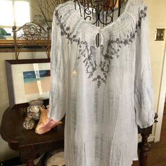 Great Looking Top Can Be Worn Off The Shoulders. Super Versatile As A Top, Beach Cover-Up, Or Short Dress For The Summer. Has Two Toned Fabrication White And Light Gray Casual Embroidered Summer Tunic, White Casual Tunic With Floral Embroidery, Casual Embroidered White Tunic, Casual White Embroidered Tunic, Embroidered White Tops For Beach Season, Casual Beach Tunic With Floral Embroidery, Casual Embroidered Tunic For Vacation, Long Sleeve Top With Embroidered Neckline For Beach, Long Sleeve Tops With Embroidered Neckline For Beach