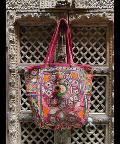 About bag  Indo-gypsy fusion, everyday use hand bag made from Banjara fabrics sourced from Vintage tribal costumes of regions of Rajastan and Gujarat. These are embellished with light catching coins, and intricate bead work tassels. Size - length 15 inches/ width 21 inches Company details:  Company name: Houseoftextile  Contact number: +919784447473  Email id: houseoftextile77@gmail.com  Shipping & custom : Delivery through one of the finest service providers : Skyway, Fedex, UPS  And DHL. Any l Multicolor Rectangular Bag With Zari Work, Traditional Pink Tote Bag, Bohemian Multicolor Bags With Zari Work, Bohemian Multicolor Potli Bag For Festive Occasions, Bohemian Multicolor Potli Bag For Festive Season, Multicolor Bohemian Potli Bag For Festive Occasions, Bohemian Multicolor Zari Work Bag, Festival Tote Bag With Handwork, Traditional Bags With Mirror Work For Festivals