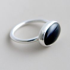 This sterling silver ring features an oval, black onyx stone in a custom bezel setting.  The stone has a glossy shine and is dark and dramatic. Clean classic lines, perfect for everyday wear. Black onyx is said to be helpful for relieving stress and aiding with emotional stability.  Also said to be a protective stone that helps to release negative emotions while defending against negativity directed towards you. Stone measures 14mm x 10mm. I can create this ring for you in either brushed or shiny finish. Available in size 4, size 4.5, size 5, size 5.5, size 6, size 6.5, size 7, size 7.5, size 8, size 8.5, size 9, size 9.5, size 10, size 10.5, size 11, size 11.5, size 12, size 12.5, size 13  Also available with stone set vertically here: http://www.etsy.com/listing/73060906/black-onyx-sterl Nail Bracelet, Imperfectly Perfect, Sunflower Jewelry, Diamond Choker, Black Ring, Black Onyx Stone, Black Onyx Ring, Onyx Ring, Oval Stone