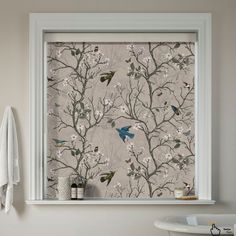 a bathroom window with birds and flowers on it