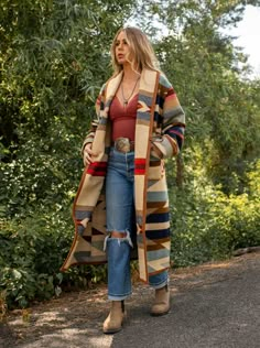 Wyeth Trail Long Stadium Coat Our Wyeth Trail Long Stadium Coat will keep you covered from top to below the knee. Made from the Pendleton Wyeth Trail wool blanket, the warm earth tone colors are easy to wear. Wear it open or close at the waist with a toggle. Designed for a slightly oversized fit and look. The Wyeth Trail blanket reflects warm, harmonious colors of ancient corn varieties patterned in rows similar to ancient Native American gardens. Arrows point in two directions, the past and the Long Flannel Duster, Western Inspired Fall Outfits, Big Sur Style Fashion, Blanket Coat Outfit, Native Clothing Women Style, Southwest Jacket Outfit, Native American Modern Fashion, Fall 2024 Western Fashion Trends, Elegant Bohemian Fashion